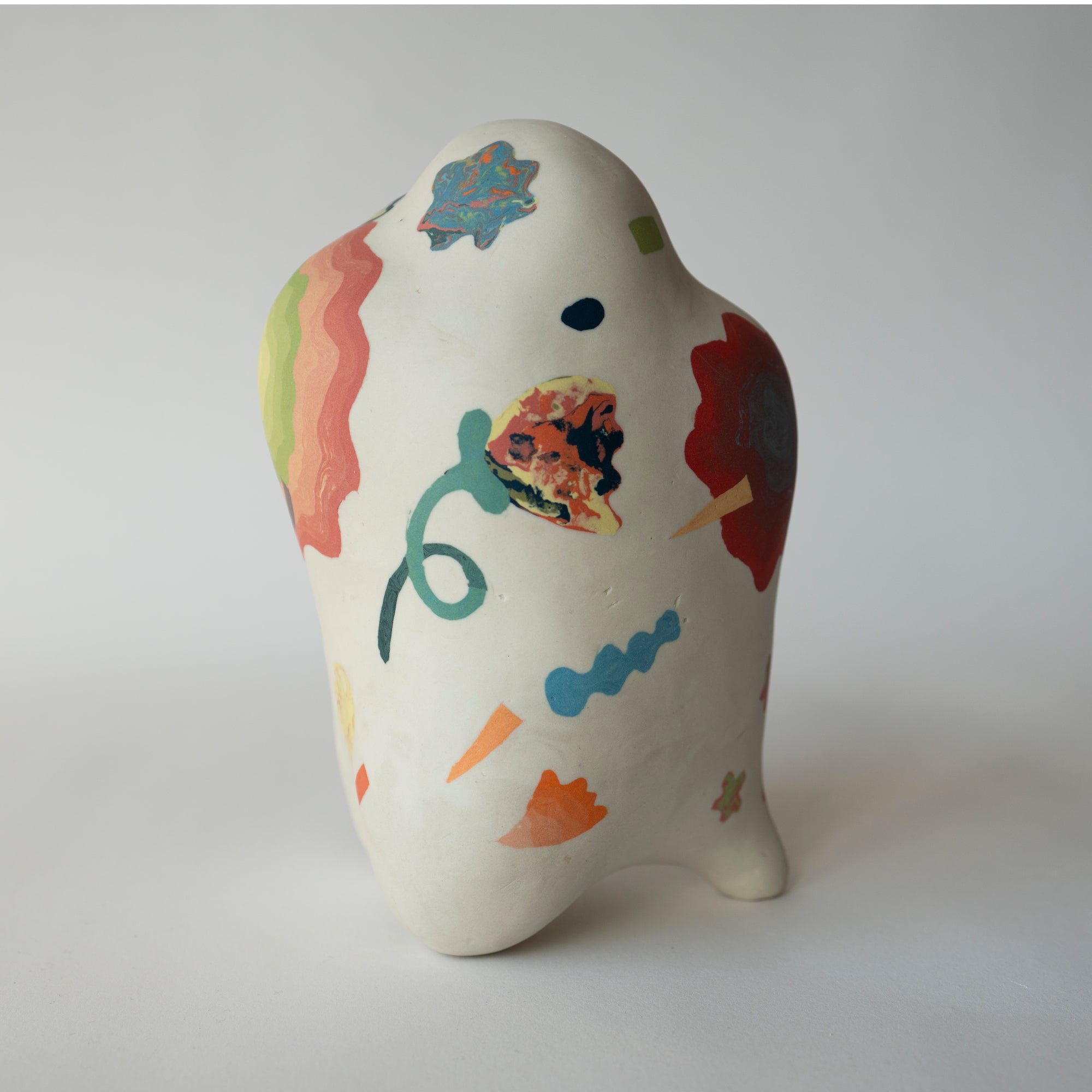 Ceramic piece with colorful abstract designs on a white background