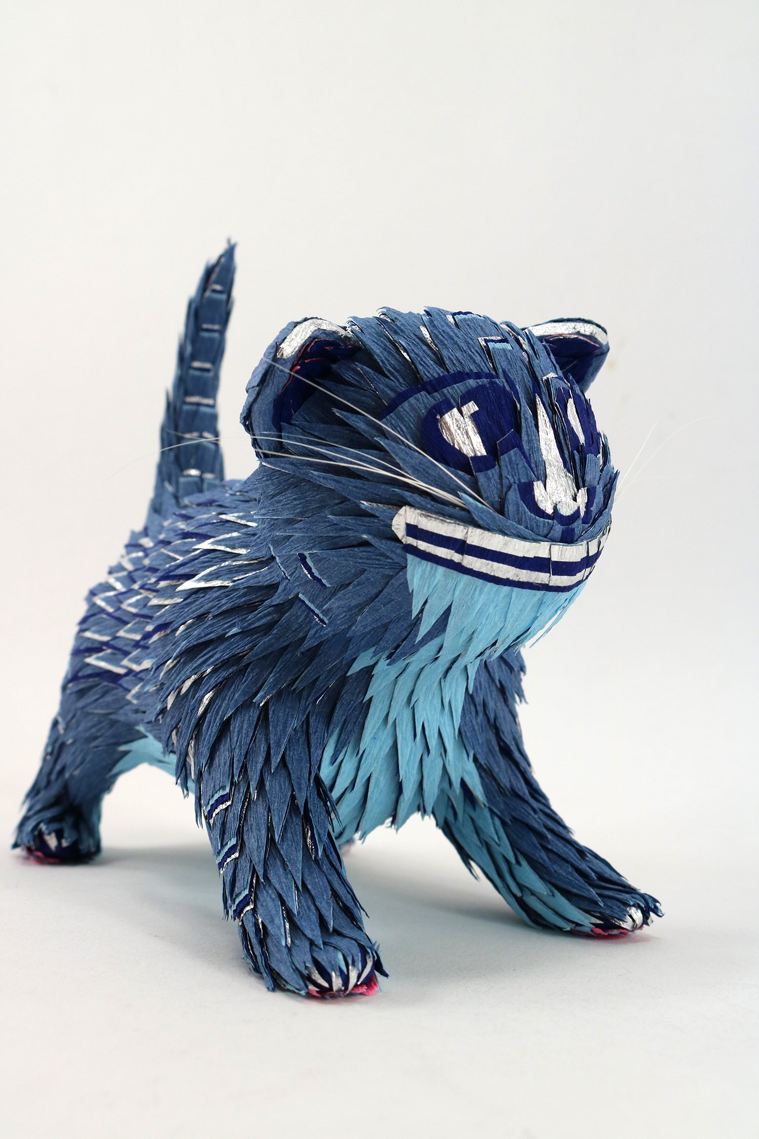Blue cat-shaped sculpture on a white background