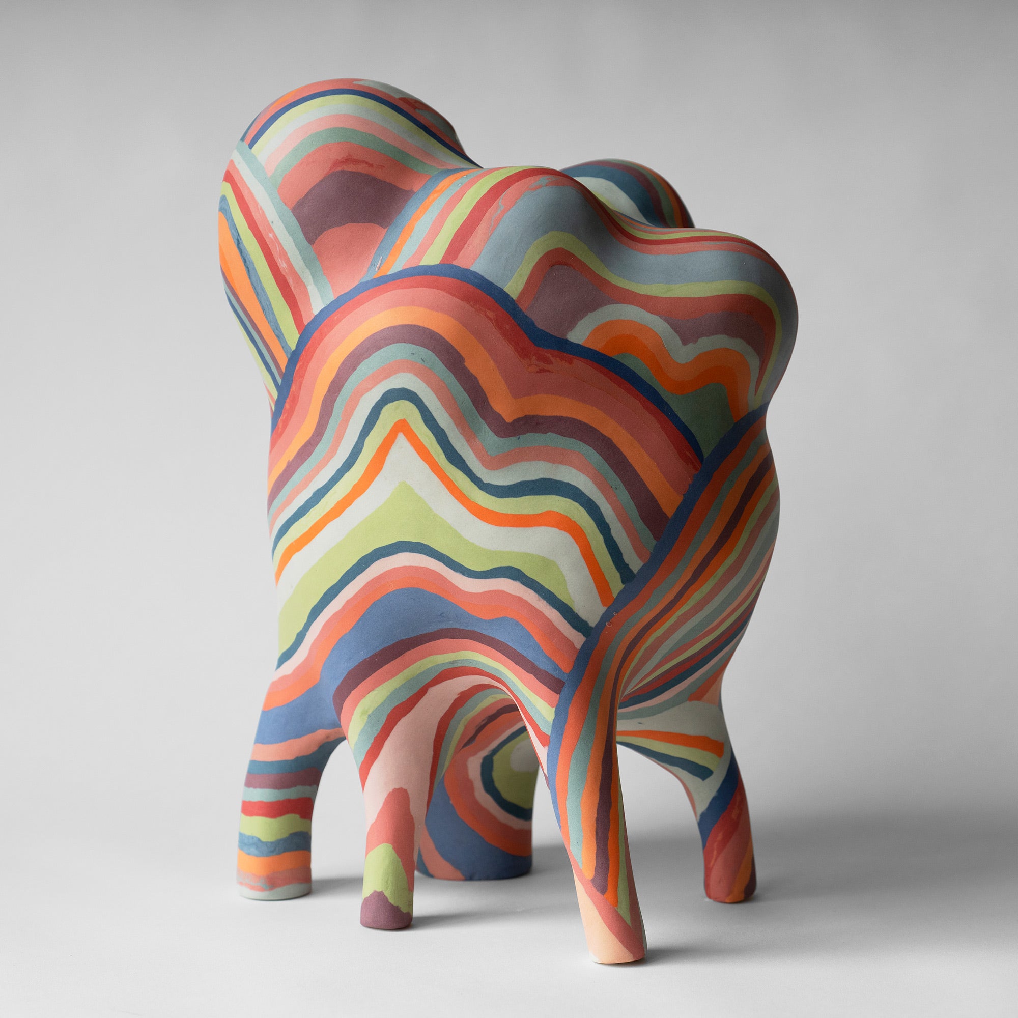 a colorful sculpture with wobbly lines and five legs