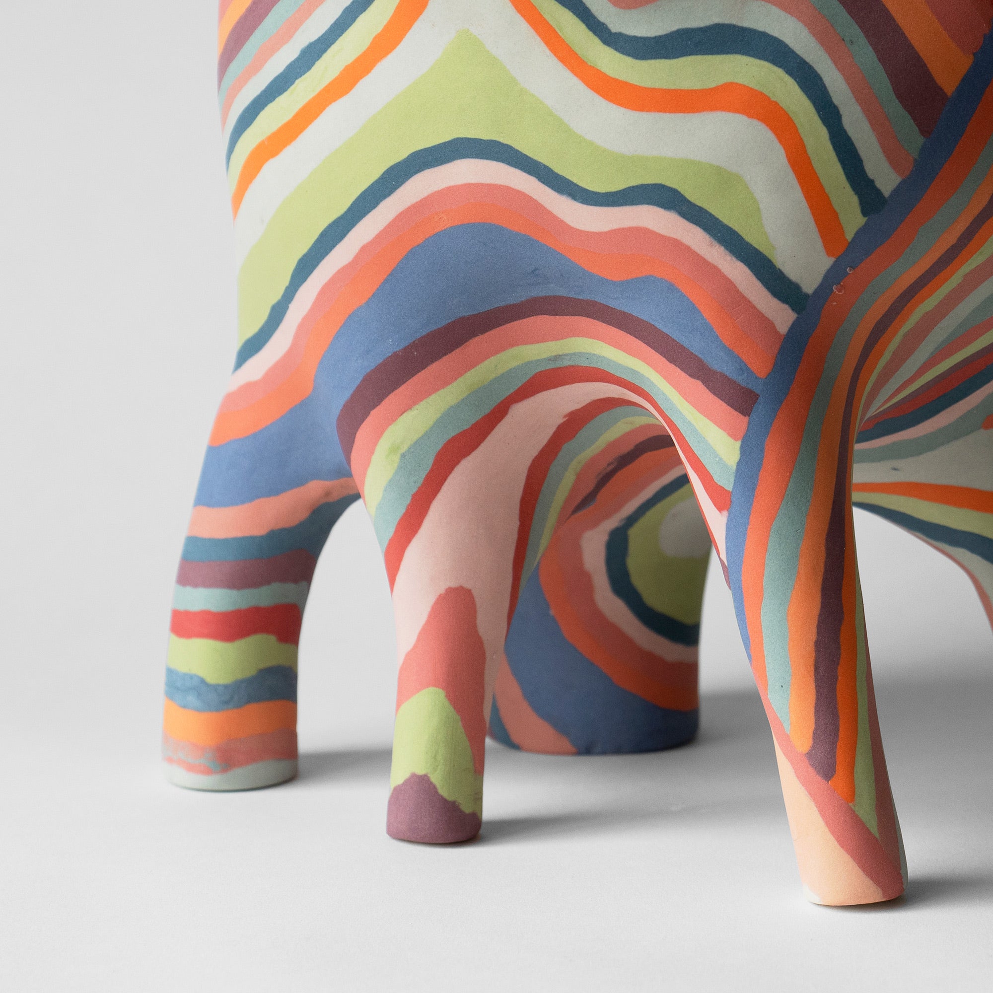 a colorful sculpture with wobbly lines and five legs